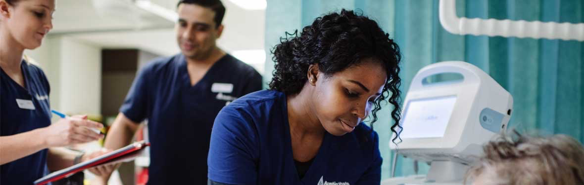 A nurse treats a patient in the Emergency Department